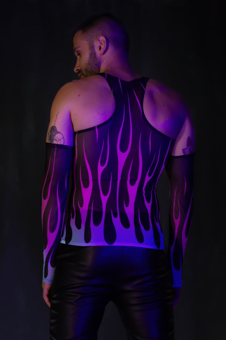 Flames flicker with your every move as the ultraviolet lights embrace you, leaving a trail of light in the darkness of night. FEATURES: >Slim Fit >Tank Top Cut >Long Fingerless Gloves >Luxurious & Silky, See-Through Mesh Fabric >UV Reactive Ink >95% Polyester / 5% Elastane Fitted Rave Tops For Halloween, Rave Sleeveless Tank Top For Festival, Sleeveless Rave Tank Top For Festivals, Fitted Purple Tank Top For Night Out, Purple Sleeveless Club Top, Sleeveless Stretch Rave Tops, Stretch Sleeveless Rave Tops, Rave Sleeveless Tops For Club, Purple Tank Top For Party