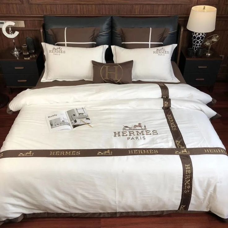 a bed with white and brown comforters on top of it