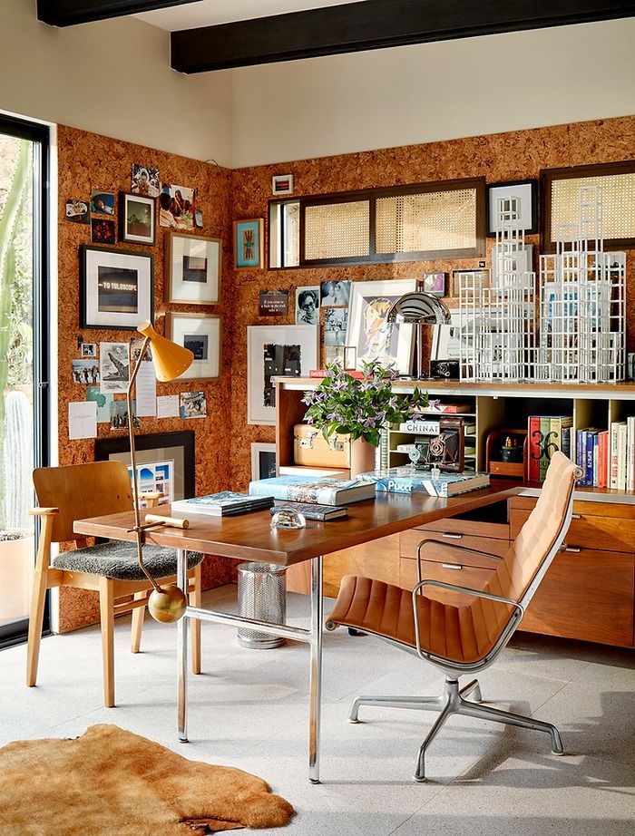 a home office with an open bookcase, desk and chair in front of a large window