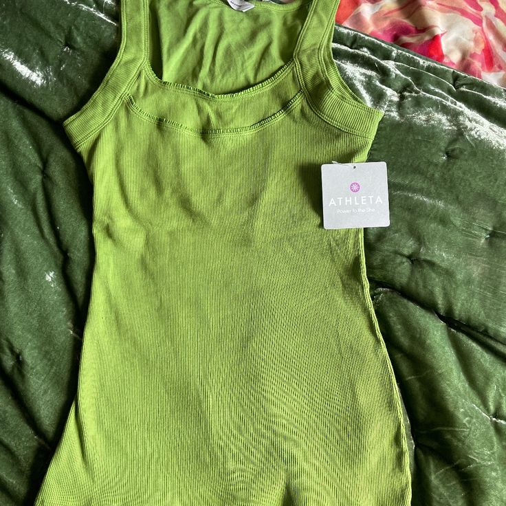 Athleta Green Tank. Size M New With Tags. Casual Green Seamless Activewear, Spring Fitted Sports Tank Top, Fitted Spring Sports Tank Top, Fitted Tank Top For Spring Sports, Sporty Fitted Tank Top For Spring, Spring Green Racerback Activewear, Green Scoop Neck Top For Gym, Green Scoop Neck Athleisure Top, Green Scoop Neck Top Athleisure Style