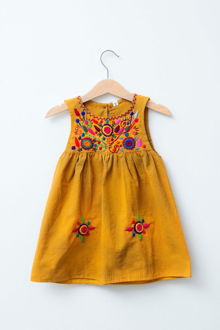 Our colorful Jardinita dresses are made of cotton are hand-embroidered making each one unique! Dresses are sleeveless and come with a button and loop on the back of neckline to secure. - available in sizes 0-4, 6 & 8 see size chart for measurements - as these are all one of a kind embroidery, color may differ from Fitted Sleeveless Embroidered Sundress, Sleeveless Embroidered Sundress, Sleeveless Cotton Embroidered Dress With Embroidered Hem, Sleeveless Cotton Dress With Embroidered Hem, Fitted Sleeveless Embroidered Dress, Folk Cotton Dress With Geometric Embroidery, Folk Style Cotton Dress With Geometric Embroidery, Traditional Sleeveless Cotton Embroidered Dress, Traditional Sleeveless Embroidered Cotton Dress