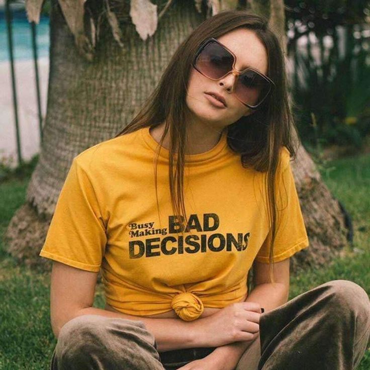 Get ready to turn heads with our Busy Making Bad Decisions Tee! This yellow t-shirt features bold, eye-catching text and is made from high-quality materials to ensure a comfortable fit. Available in a range of sizes, this t-shirt is perfect for anyone looking to make a statement. Whether you're out on the town or hanging out at home, this t-shirt is sure to become a wardrobe staple. So why wait? Add this unique and stylish t-shirt to your collection today! Collar: O-Neck Material: 100% Cotton Cl Tumblr Aesthetic Clothes, E Girl Style, Grunge Tops, Feminist Tees, Egirl Outfits, 80s And 90s Fashion, Rainbow Outfit, Bad Decisions, Tumblr Outfits