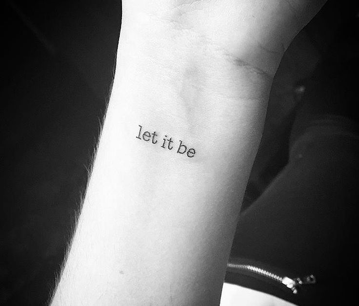 a person with a tattoo on their arm that says let it be