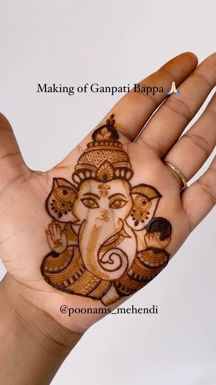 the hand is decorated with henna and an elephant's head on top of it