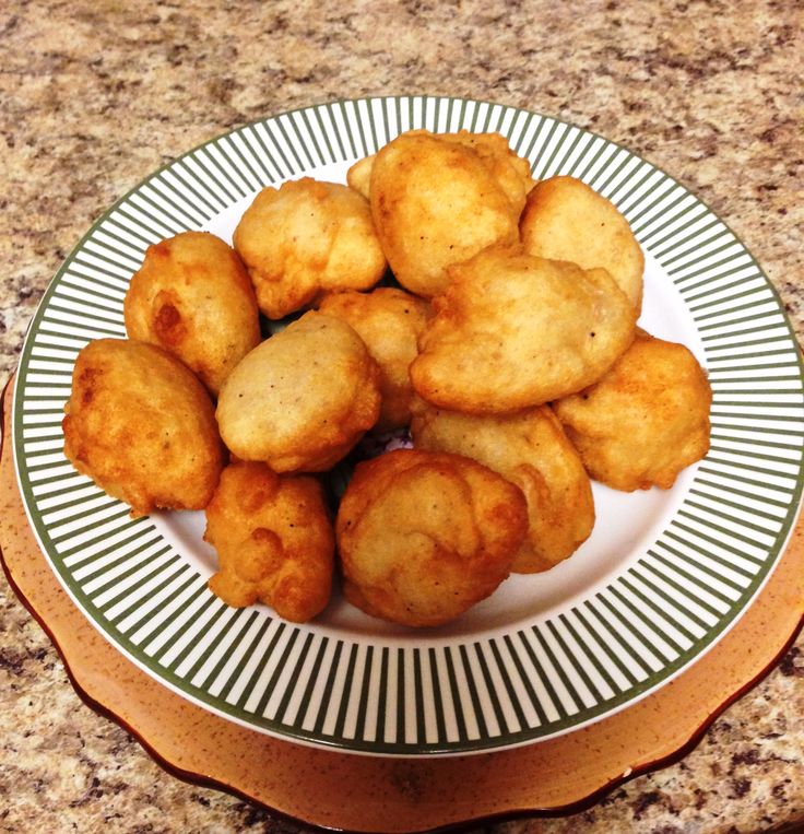 some fried food is on a plate on the counter top, ready to be eaten