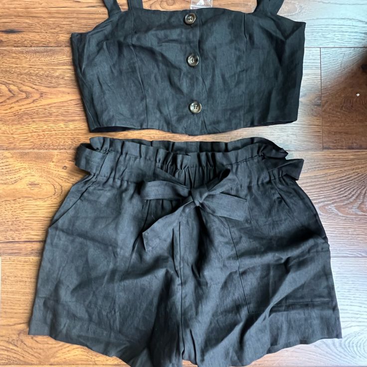 New Never Worn. Black Two Piece Set With Paper Bag, Tie Waist Shorts And Top. Straps Have Two Button Adjustment And Buttons In Front Are Functional. Size Medium. Chic Black Shorts With Buttons, Black Shorts With Buttons For Spring, Casual Black Shorts With Button Closure, Black Bottoms With Buttons For Summer, Black Buttoned Bottoms For Summer, Summer Black Bottoms With Button Closure, Black Casual Shorts For Going Out, Casual Black Shorts For Going Out, Black Button Closure Shorts For Summer