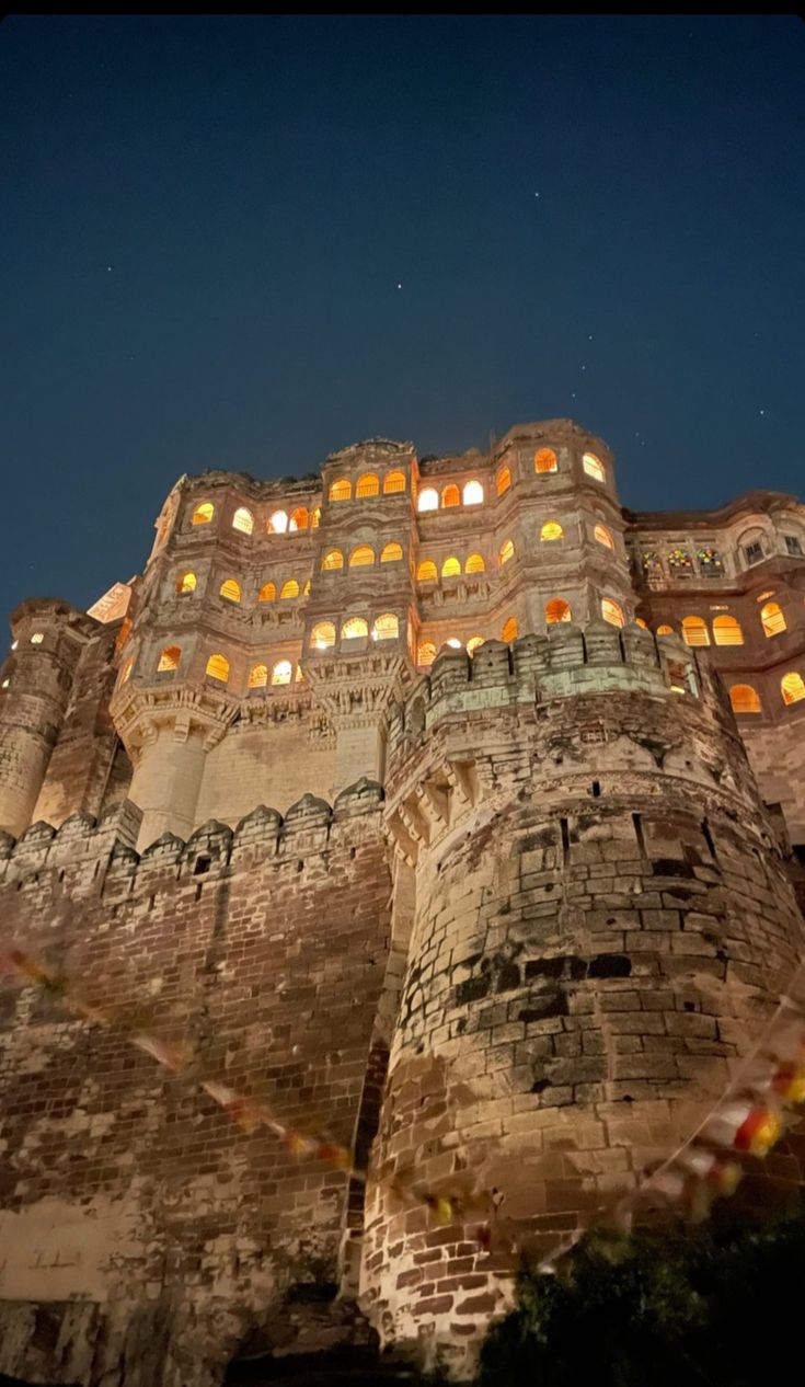 an old castle lit up at night