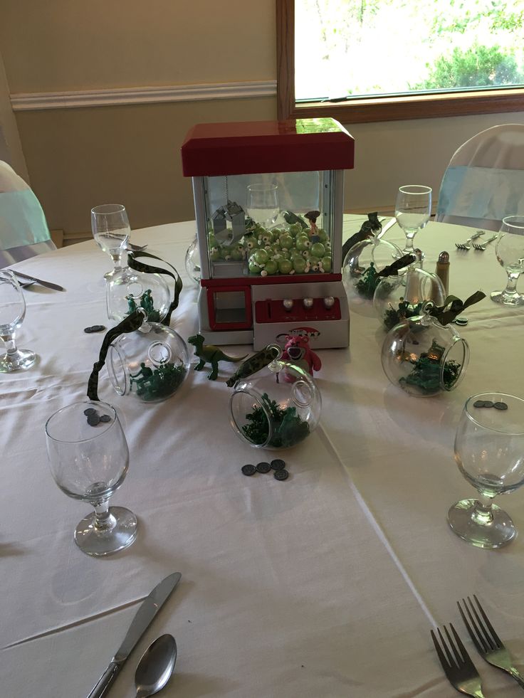 the table is set with wine glasses, silverware and an ornament on it