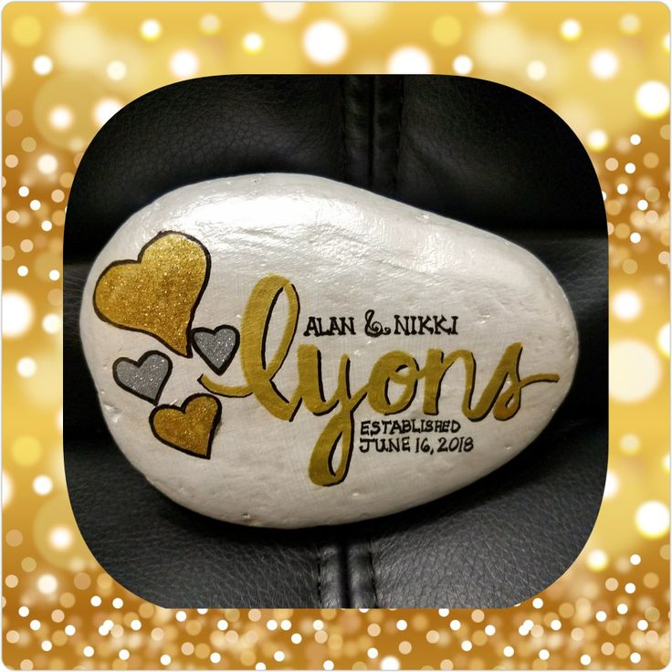 a white rock with gold hearts and the words lynns written on it in black leather