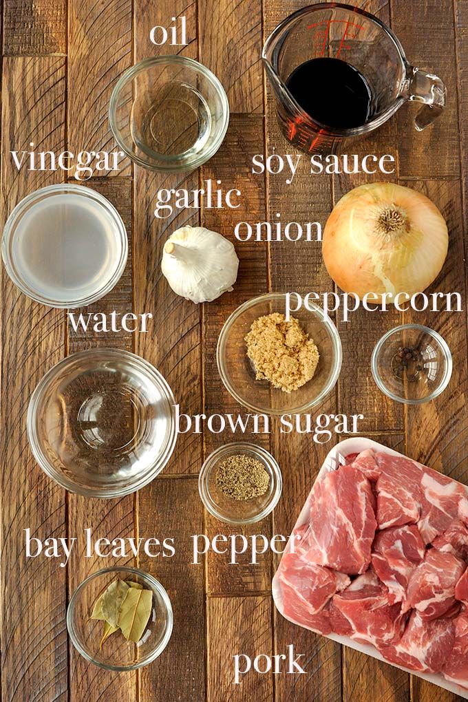 ingredients to make an apple cider recipe laid out on a wooden table with text overlay