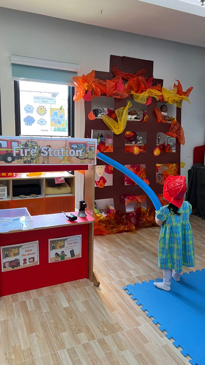 a child in a room with wooden floors and toys on the floor next to it