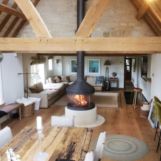 a living room filled with furniture and a fire place in the middle of it's center