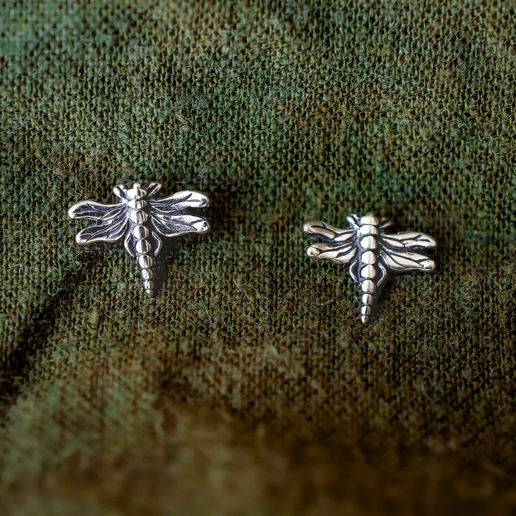 These Dragonfly Stud Earrings are the perfect everyday accessory. Crafted from sterling silver, dragonflies symbolize strength and change. Elevate any outfit with these delicate yet impactful studs. DRAGONFLY STUD EARRING DETAILS: Sterling silver (.925). Dragonflies measure approx. 8 mm. Stud earrings with a post and ear nut closure. Bee Studs, Busy Bees, Jewelry Card, Everyday Accessories, Dragonflies, Stud Earring, Bumble Bee, Ring Necklace, Nature Inspired