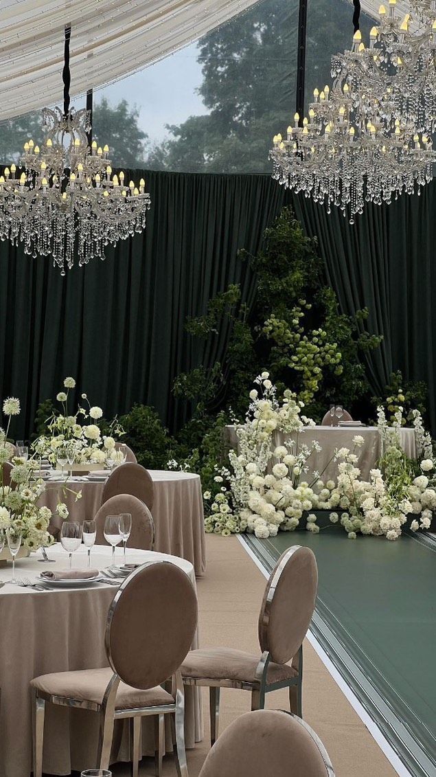 an elegant wedding setup with chandeliers and tables set up for the guests to eat