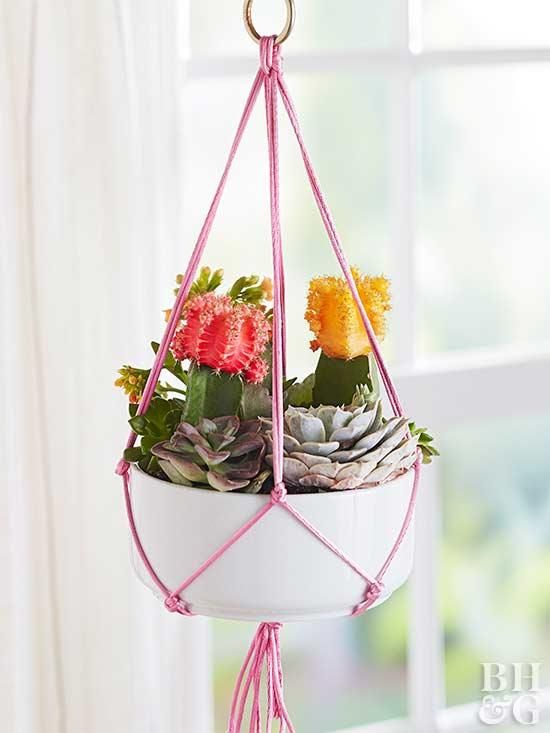 a hanging planter filled with succulents and flowers