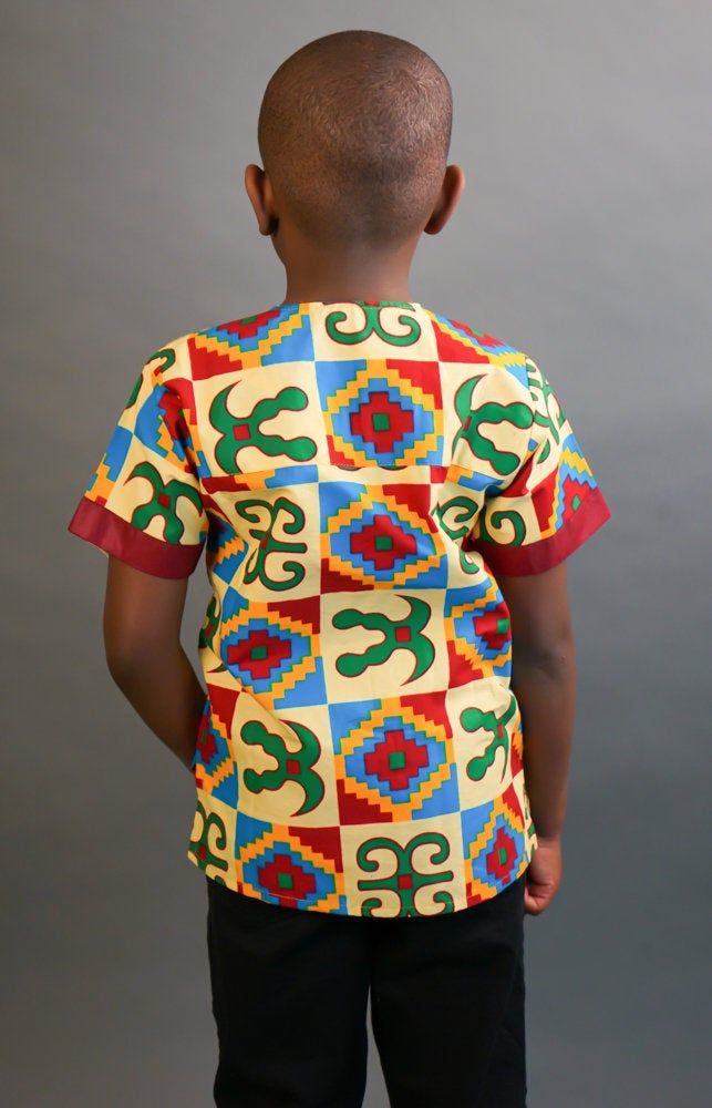 This short sleeved African Kente shirt is real cute. Dress him up in this cute African outfit and he will attract a lot of attention and draw tons of compliments. He can wear it whenever he wants to project his African Identity. He can wear it during Sankofa, Kwanzaa, and any African American or Afrocentric Cultural event. *Hand Sewn African Dress *Made by Local Artisans in Africa *100% Cotton *Made in Ghana *Portions of proceeds donated to charities in Africa *Everything in stock is available i Printed Cotton Half Sleeve T-shirt, Casual Multicolor Print T-shirt, Casual Multicolor Patterned T-shirt, Casual Multicolor T-shirt With Colorful Pattern, Casual Multicolor Print T-shirt With Colorful Pattern, Casual T-shirt With Colorful Multicolor Print, Casual Yellow Tops With Colorful Pattern, White Short Sleeve Tops With Colorful Pattern, Traditional Cotton Crew Neck Shirt