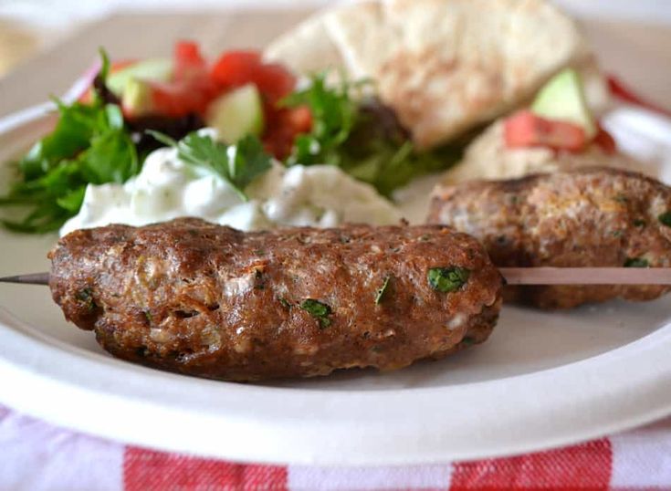 a white plate topped with meat and vegetables