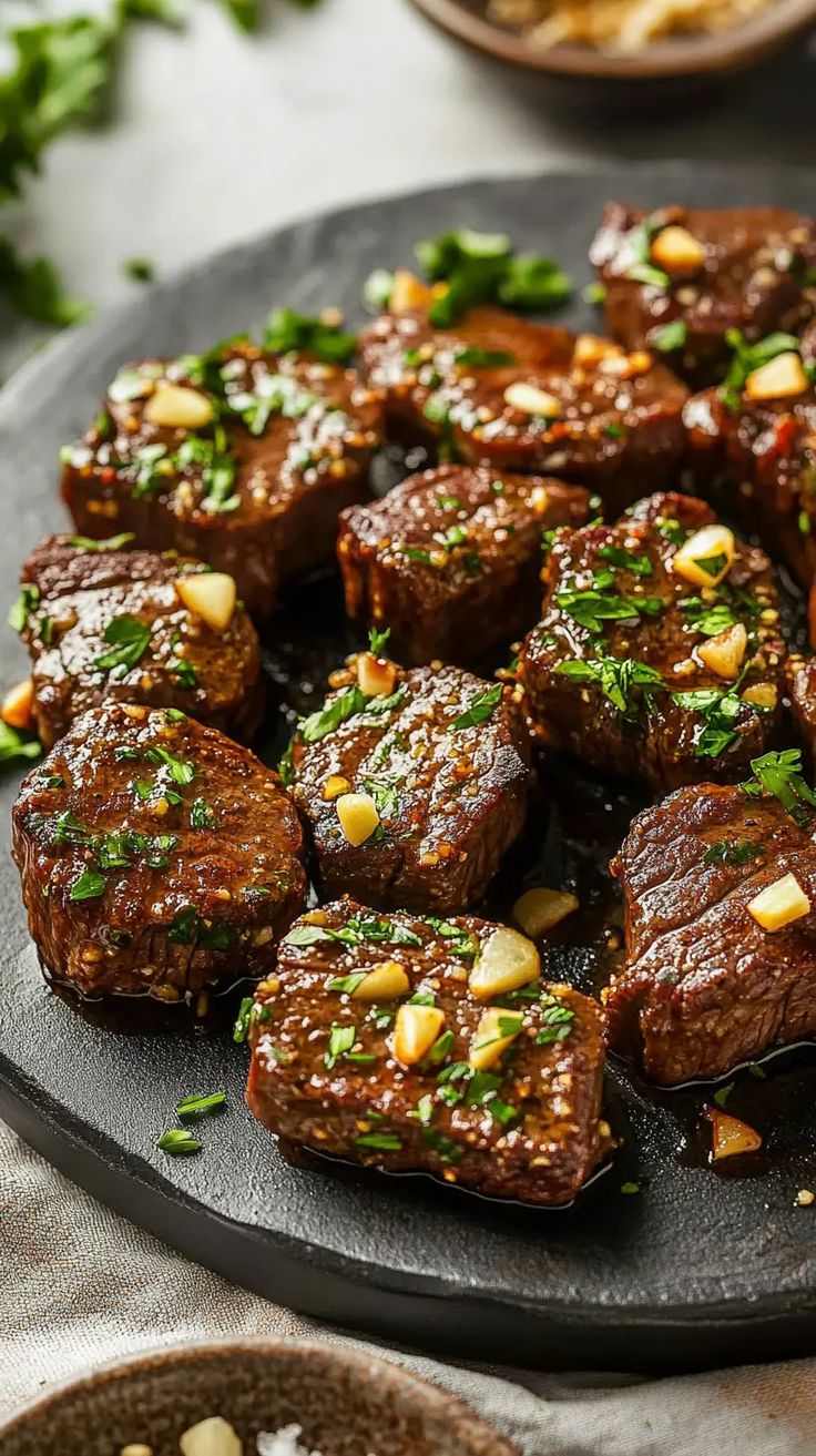 a plate full of cooked meats and garnished with parsley on top