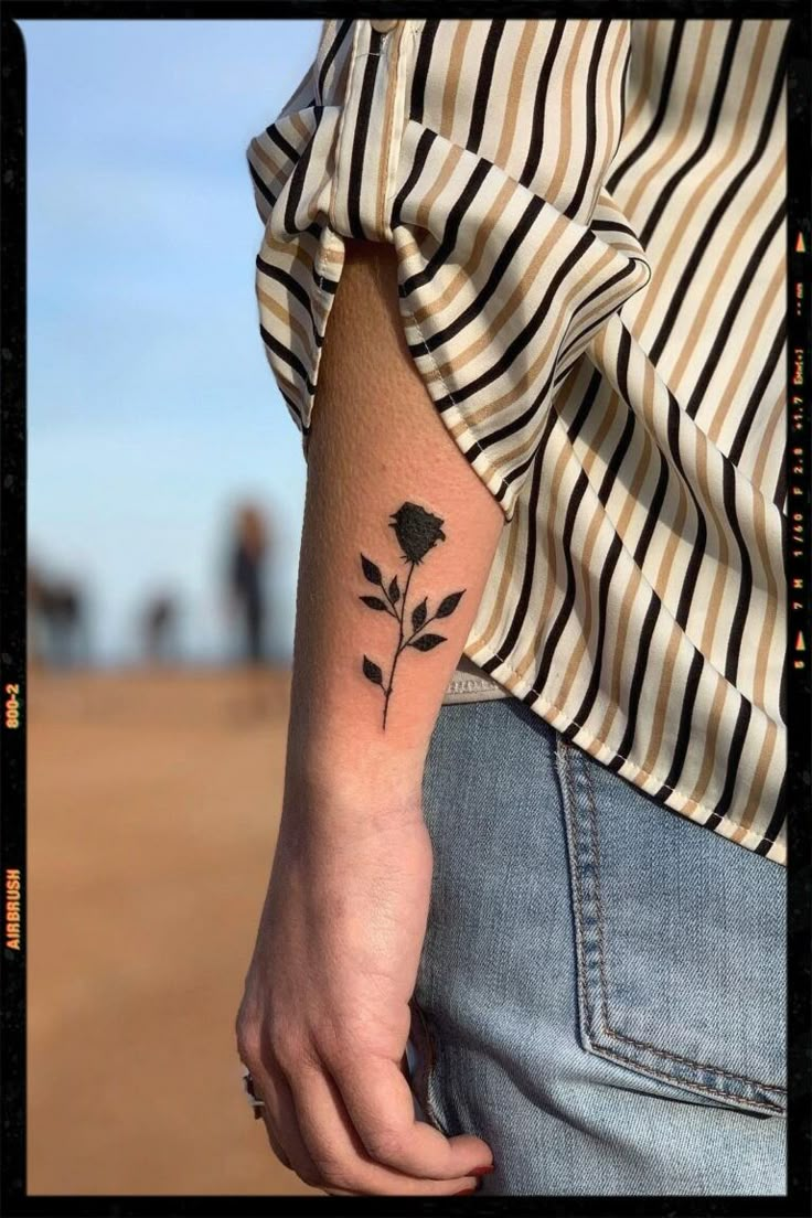 a person with a flower tattoo on their arm