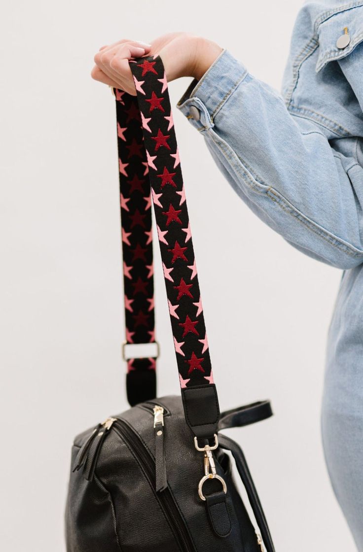 A bag strap is the easiest way to give your favorite carryall an instant refresh. The Nova Straps feature a playful star pattern in the cutest colorways. Now the only question is, which one will you choose? Details: Adjusts from 29" to 51" long 1.75" wide Trendy Adjustable Pink Bag Strap, Black Star-shaped Shoulder Bag For Everyday Use, Casual Black Bag Strap With Adjustable Straps, Trendy Black Shoulder Strap With Adjustable Straps, Casual Black Bag Strap With Long Strap, Casual Black Bag With Long Strap, Casual Black Long Bag Strap, Adjustable Red Bag Strap For Everyday Use, Red Crossbody Shoulder Strap For Daily Use