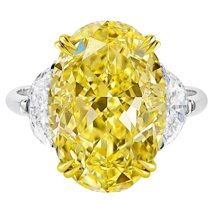 This exquisite ring features a captivating 5.10 carat fancy light yellow oval diamond as its centerpiece, certified by GIA. The vibrant yellow diamond is set in 18K white gold, creating a stunning contrast that enhances it's rich color. Flanking the central stone are two elegant half moon diamonds, adding balance and brilliance to the overall design. The double prongs, crafted in 18K yellow gold, securely hold the diamond while subtly accentuating it's radiant hue. With a VS1 clarity grade, the Oval Diamond Solitaire Ring, Fancy Yellow Diamond Ring, Oval Diamond Solitaire, Oval Cut Diamond Rings, Trillion Diamonds, Yellow Diamond Ring, Contemporary Engagement Rings, Oval Diamond Ring, Yellow Diamond Rings