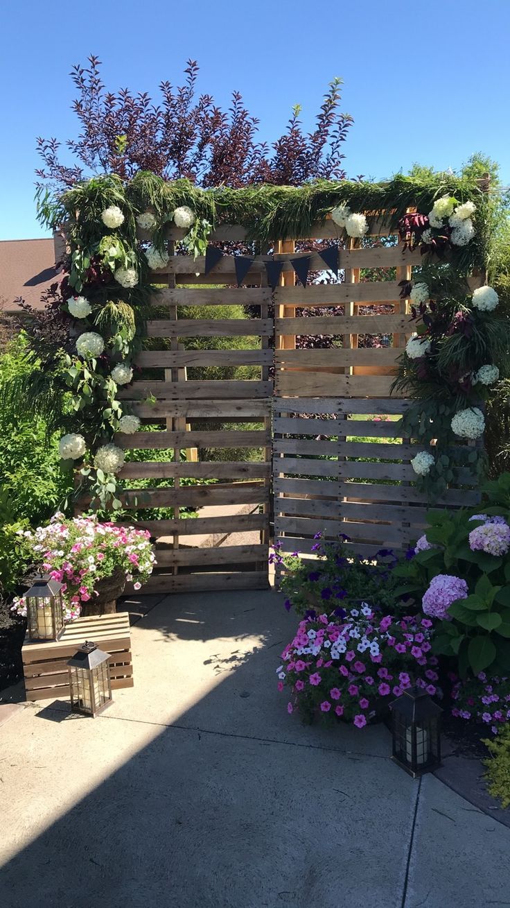 a wooden fence with flowers growing on it