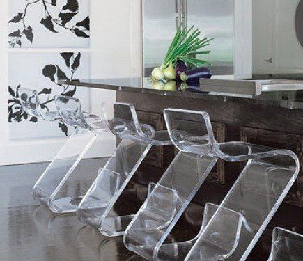 the kitchen counter is lined with clear plastic chairs