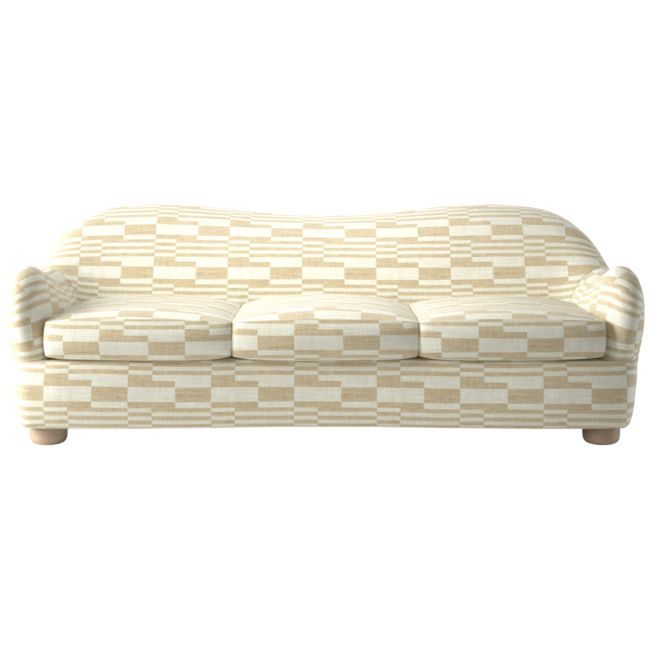 a white and beige checkered couch sitting on top of a wooden table