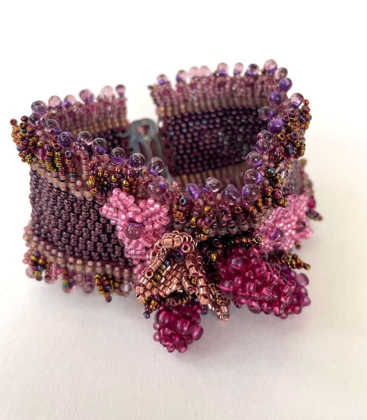 A beautifully detailed hand crafted cuff bracelet adorned with bramble berries in lovely jewelled tones. Part of a three piece set comprising of a cuff bracelet, a brooch and lariat necklace, but can be purchased separately. Purple Beaded Bracelet Jewelry, Unique Purple Cuff Bracelet As Gift, Elegant Beaded Cuff Bracelet As Gift, Bohemian Beaded Cuff Jewelry, Unique Purple Cuff Bracelet For Gift, Elegant Beaded Cuff Jewelry, Purple Beaded Bracelets For Wedding, Elegant Beaded Cuff Bracelet For Gift, Beaded Cuff Bracelet Gift