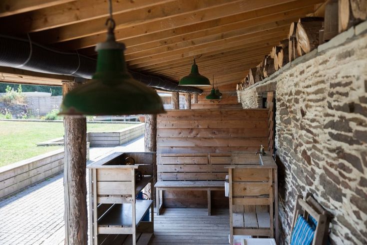 an outdoor area with wooden benches and lights