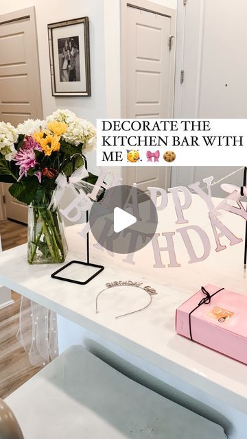 a vase with flowers on top of a counter next to a sign that says decorate the kitchen bar with me