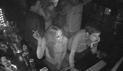 a group of people standing around a bar