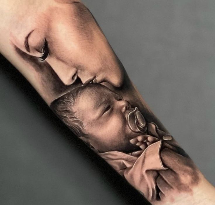 a man's arm with a tattoo on it that has a photo of a child