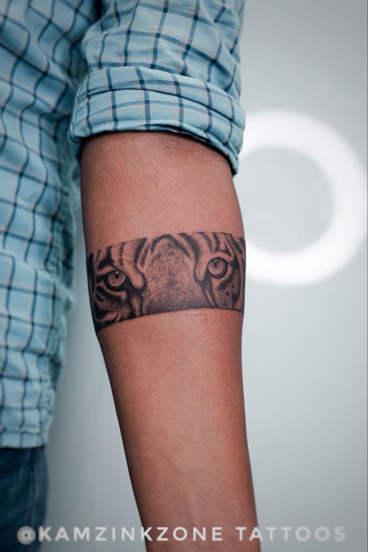 a man with a tiger tattoo on his arm