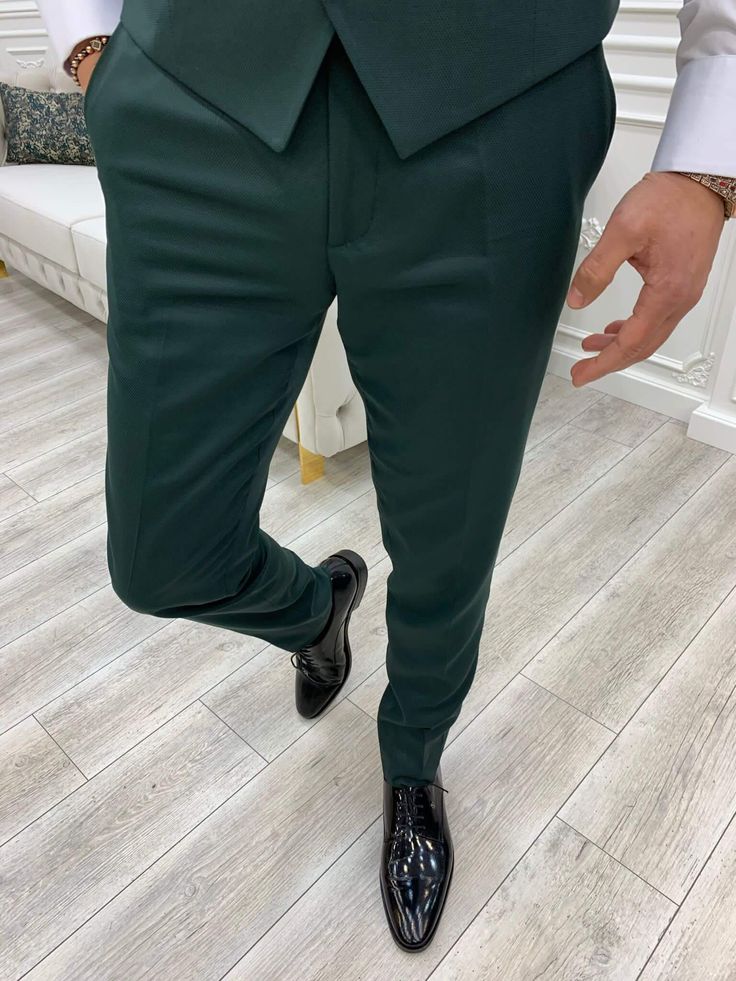 We're featuring a slim-fit buttoned shawl collar green tuxedo. From the HolloMen fall-winter '23 collection. Tuxedo Color: Green The suit's fabric includes 65% Polyester, 32% Viscone, and 3% Lycra. Its jacket has a shawl collar, double slits, flap pockets, and single buttons and it is fully canvassed. Suit Care Instructions: Dry clean only In your package, we will include a jacket, vest, pants, shirt, and bow tie. Our model wears EU50/US40. His height and weight are 180cm by 78kg respectively. B Classic Green Double Breasted Suit For Groom, Green Double Breasted Notch Lapel Suit For Groom, Green Fitted Three-piece Suit For Groom, Fitted Green Three-piece Suit For Groom, Elegant Green Sets With Suit Collar, Fitted Green Three-piece Suit For Grooms, Green Tuxedo Party Set, Fitted Green Winter Suits, Fitted Green Three-piece Suit For Party