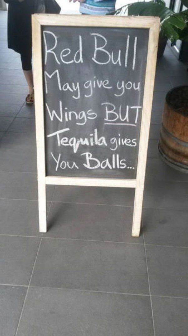 a sign that says red bull may give you wings but tequila gives you balls on it