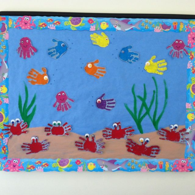 an ocean scene made out of felt with sea animals and fish on the bottom, under water