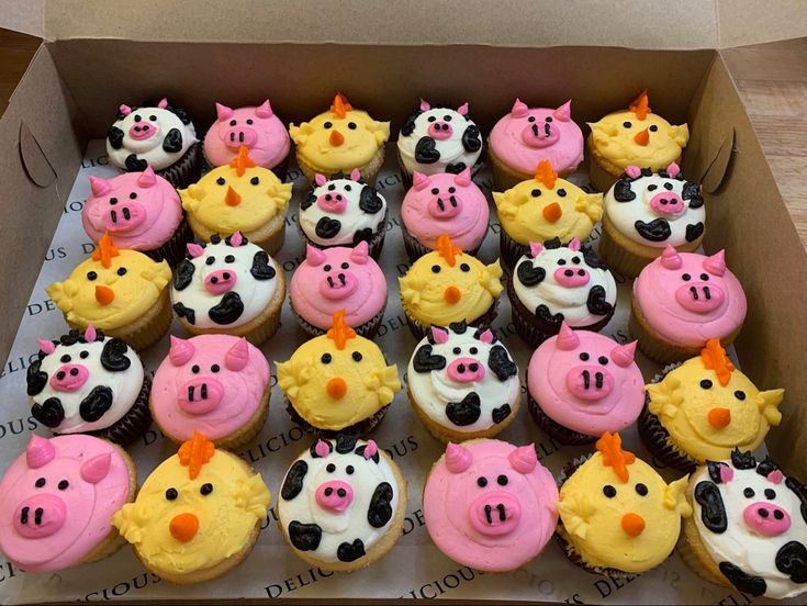 a box filled with lots of cupcakes decorated like farm animals