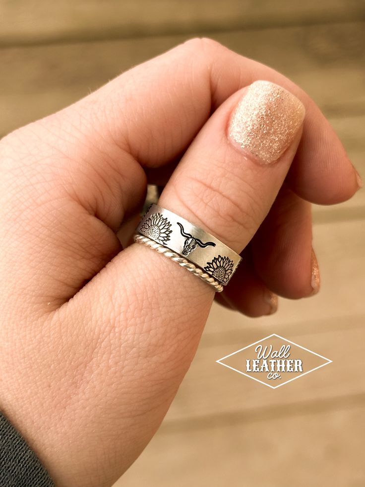 This ring is adjustable and can fit most sizes. However, if there's a particular size you'd like the ring to fit, leave a note in the comments box when you check out & we will pre-size it for you! Our rings are made of aluminum, so they’re lightweight and will not tarnish, or turn your skin green. Aluminum is also hypoallergenic and is safe to wear in water. This listing is for a single ring. The sterling silver stacker rings can be purchased separately: https://www.wallleatherco.com/products/st Cute Western Rings, Western Ring, Western Rings, Silver Wallet, Stacker Rings, Stamped Rings, Single Ring, Silver Stacking Rings, Copper Rings