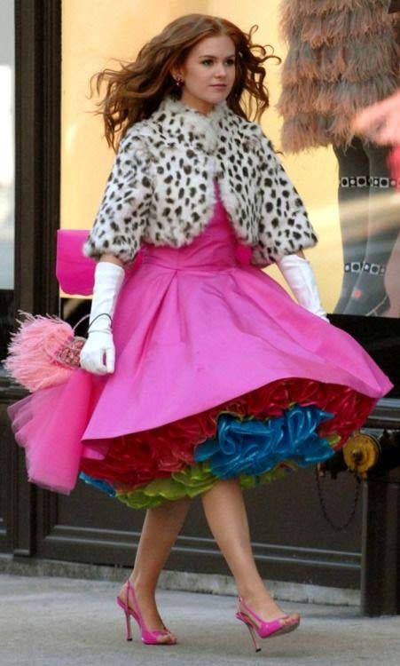 a woman is walking down the street in a pink dress and leopard print fur coat