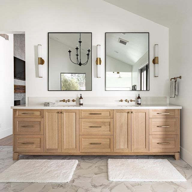 a bathroom with double sinks and mirrors on the wall above them is shown in this image