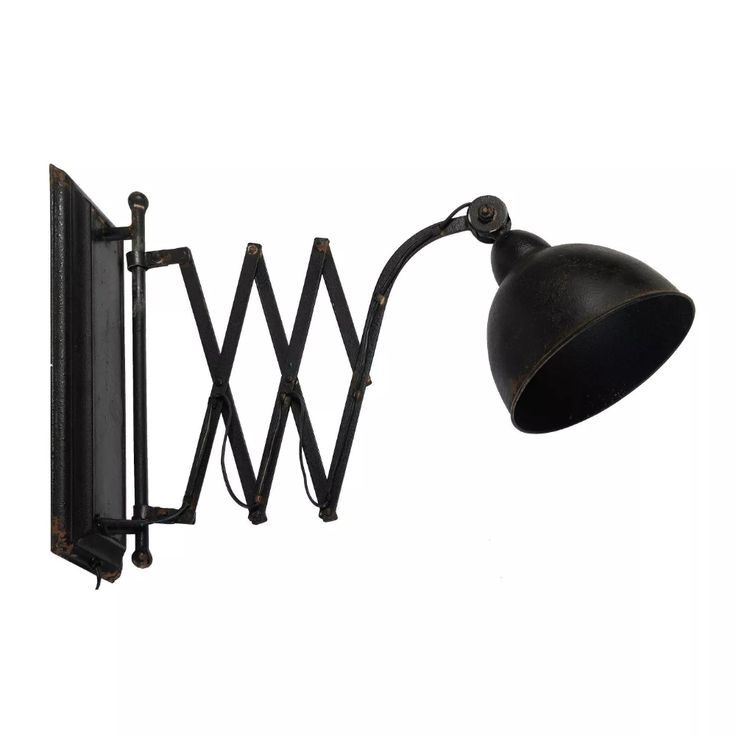 an old fashioned wall light with a black shade on it's arm and the bulb turned upside down