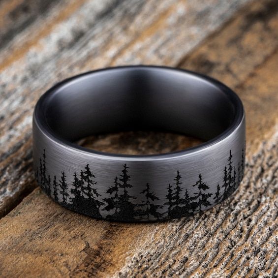 A striking forest-inspired motif rings the circumference of this handsome men's wedding band. Fashioned in tantalum, the inside of the ring is lined with smooth black tantalum to complete the look. The band features Comfort-Fit, which gives a narrower feel than it's actual width when worn. Comfort-Fit rings are designed to have a slightly rounded inside surface so less of the metal touches your finger, which enhances the feel of the ring while wearing and sliding it on and off your finger. Groom Wedding Band, Western Wedding Rings, Nature Wedding Ring, Antler Wedding Band, Mens Wedding Bands Black, Engagement Ring For Him, Stainless Steel Wedding Ring, Promise Rings For Guys, Mens Wedding Bands Tungsten