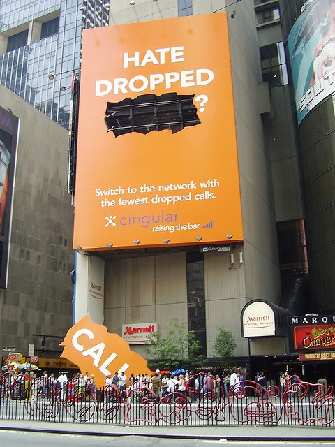 an orange sign that says hate dropped on the side of a building