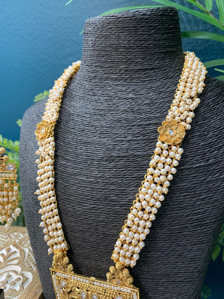 22k gold plated south style necklace / rani haar. Comes with matching earring . Adjustable dori , pearl work all over them mala and clear polki work. earring is about 2.5 inch long, push back . Gold Chandbali Pearl Necklace For Puja, Gold Kundan Necklace With Pearl Chain For Puja, Gold Kundan Necklace With Pearls For Puja, Gold Heavy Bollywood Mala, Gold Kundan Mala For Temple Jewelry, Gold Kundan Mala With Latkans, Kundan Pearl Drop Jewelry For Puja, Gold Kundan Mala For Wedding, Gold Kundan Temple Necklace With Pearl Drop