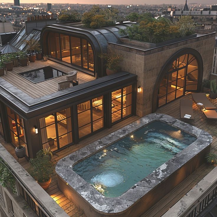 an aerial view of a house with a hot tub on the roof and lights in the windows