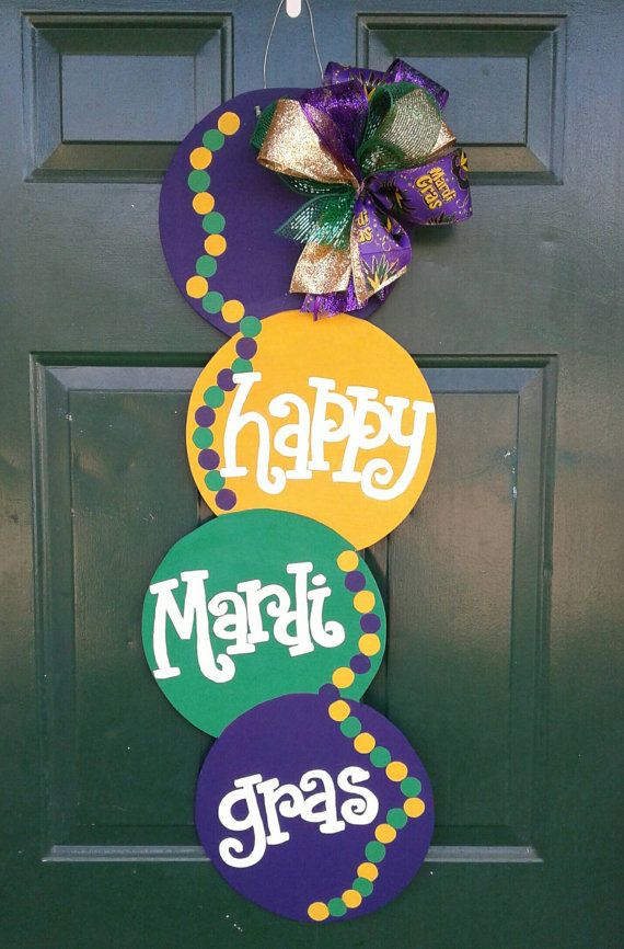 a door hanger decorated with mardi gras decorations