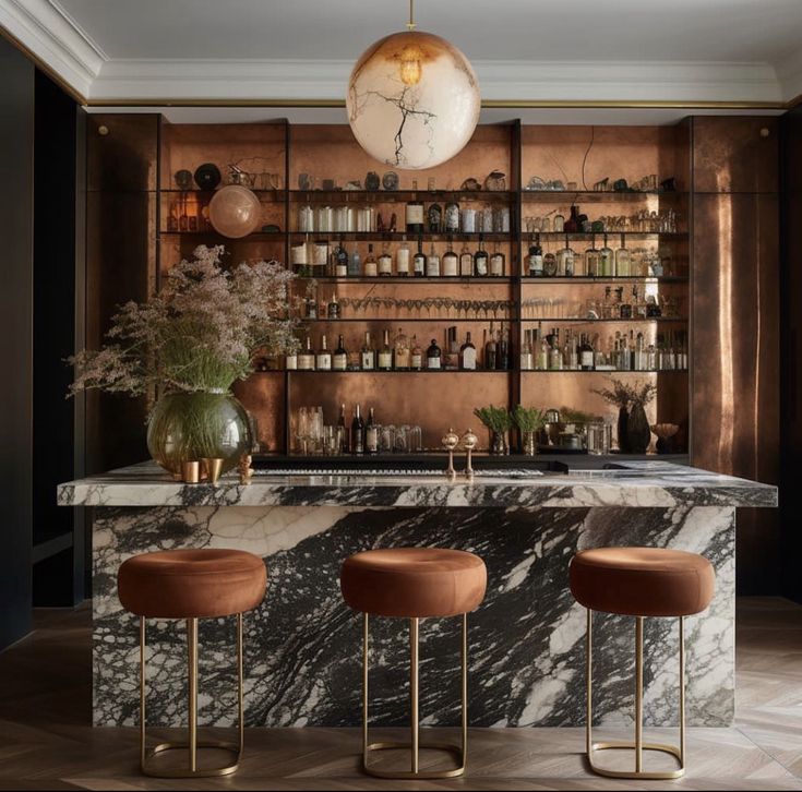 an elegant bar with marble counter tops and stools