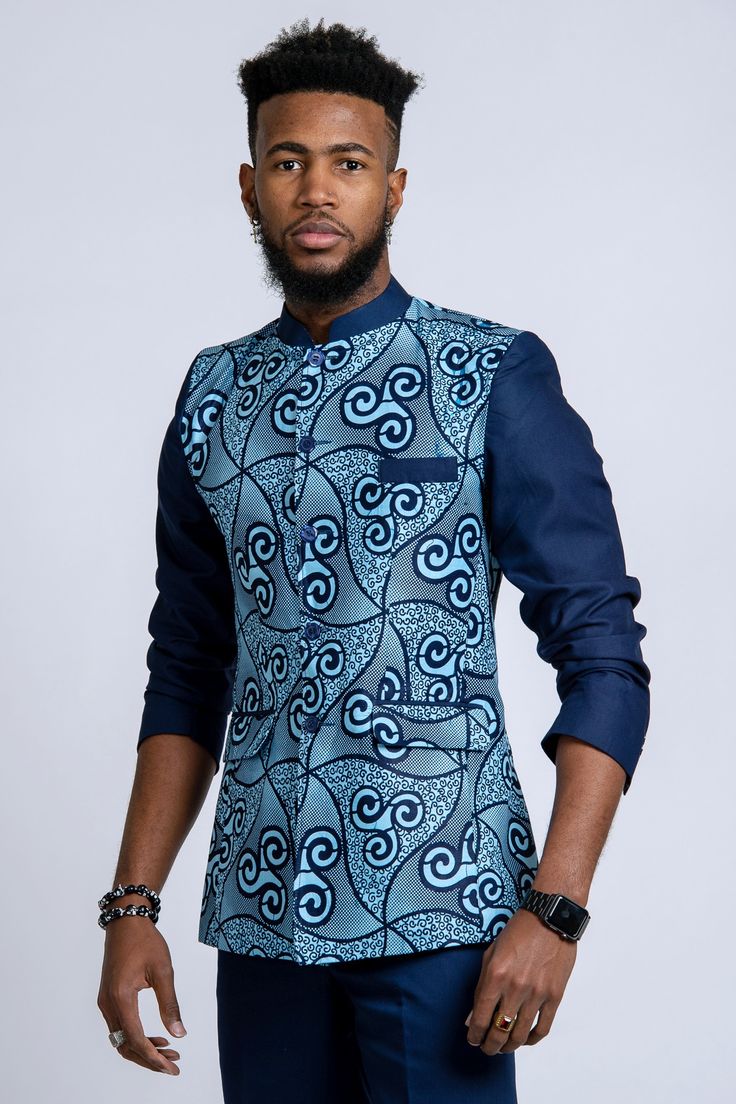 This design of African blazer for men is called Abacost. Created by President MObutu in 1972, it is a mixture of western suit and shirt.  Get a unique style with Afrilege's Abacost. More designs at afrilege.com Tailored Blue Nehru Jacket, Tailored Blue Nehru Jacket With Long Sleeves, Blue Tailored Long Sleeve Nehru Jacket, Formal Blue Nehru Jacket With Stand Collar, Blue Formal Nehru Jacket With Stand Collar, Fitted Blue Nehru Jacket For Semi-formal Occasions, Blue Fitted Nehru Jacket For Semi-formal Occasions, African Male Suits, Men African Fashion