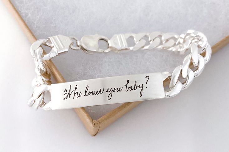 This heavy weight, sterling silver bracelet works well on all bodies. Engrave it inside and out with your own writing, fingerprints, doodles or important dates. ▪️ Qty: 1 Bracelet ▪️ Material: Sterling Silver ▪️ Engraving Plate Measures: 1.62" x .37" (41mm x 9.5mm) ▪️ Satin brushed texture. For good visibility, stay within a 10 word limit (per side) when personalizing this piece. Sizing guide is provided in the product photos. Formal Sterling Silver Engraved Name Bracelet, Engraved Link Sterling Silver Bracelet, Sterling Silver Chain Link Bracelet With Engraved Details, Silver Engraved Signature Bracelet, Adjustable Sterling Silver Name Bracelet Engraved, Love You Baby, Personalized Bracelet, Silver Engraving, Personalized Bracelets